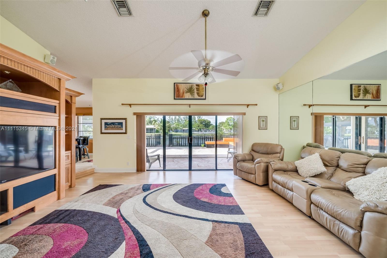 7921 Northwest 90th Avenue Tamarac, FL 33321 - Photo 11 of 69 a living room with furniture and a floor to ceiling window