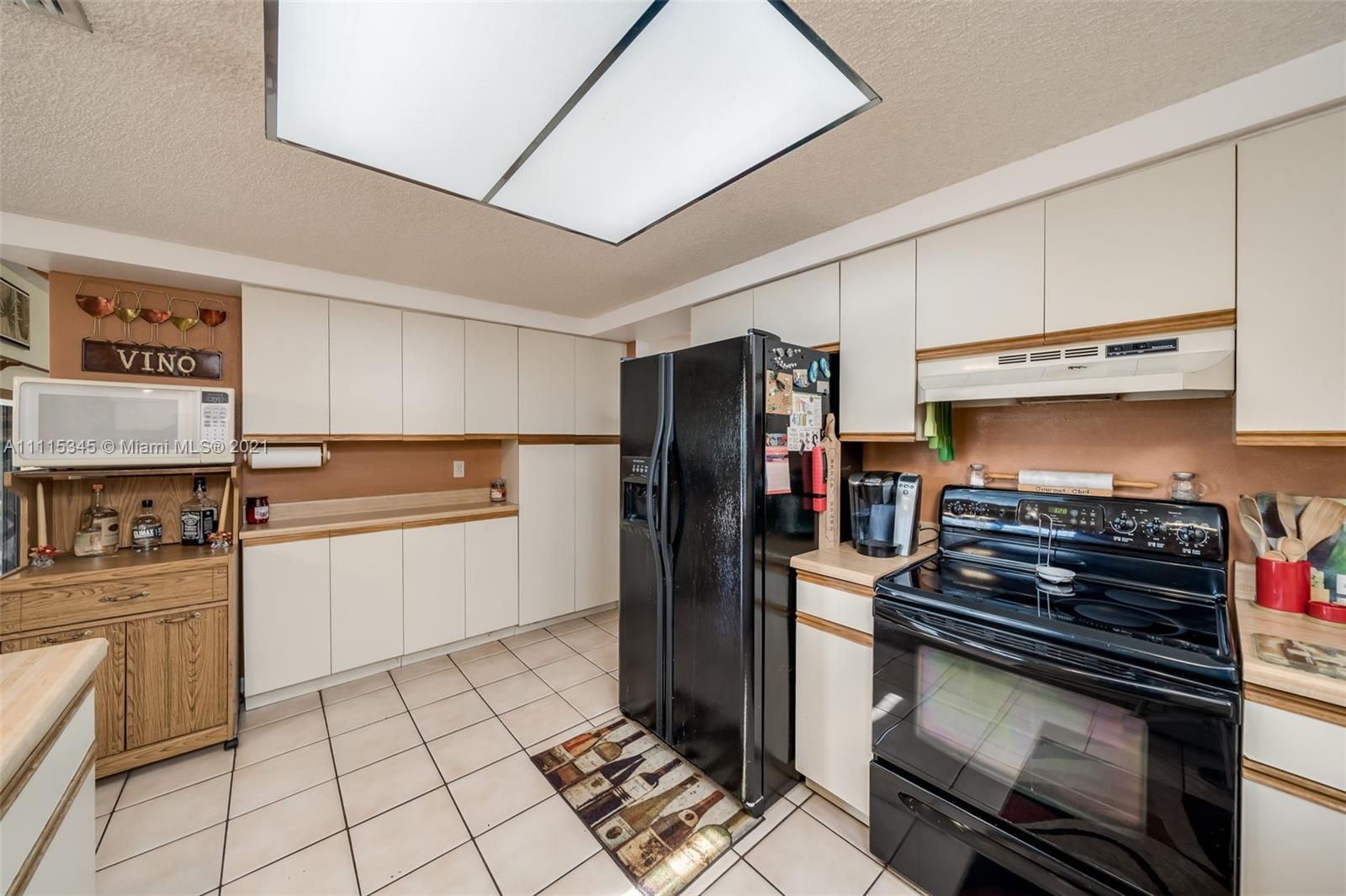 7921 Northwest 90th Avenue Tamarac, FL 33321 - Photo 18 of 69 a kitchen with a stove and a refrigerator
