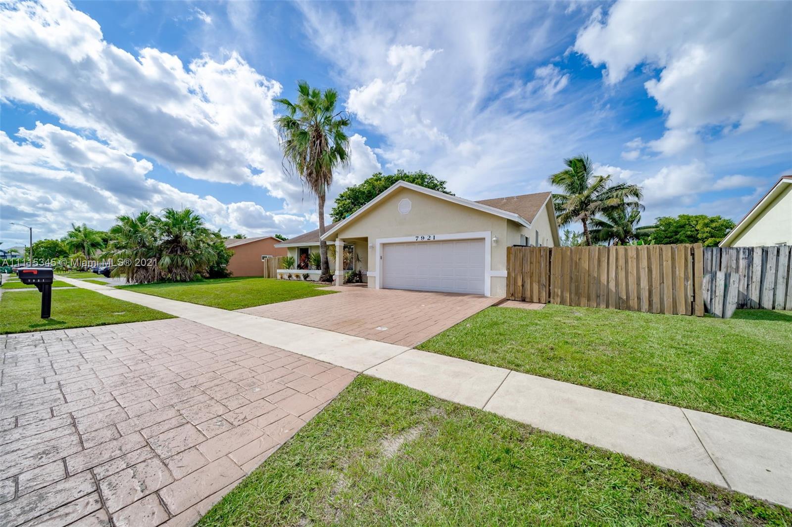 7921 Northwest 90th Avenue Tamarac, FL 33321 - Photo 2 of 69 a house with green field in front of it