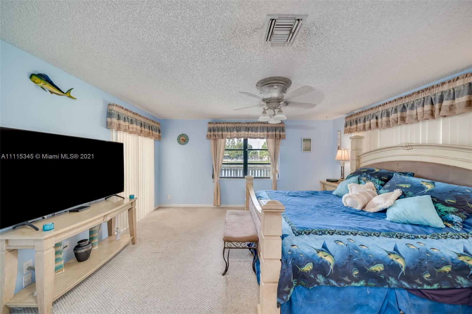 7921 Northwest 90th Avenue Tamarac, FL 33321 - Photo 24 of 69 a living room with furniture and flat screen tv