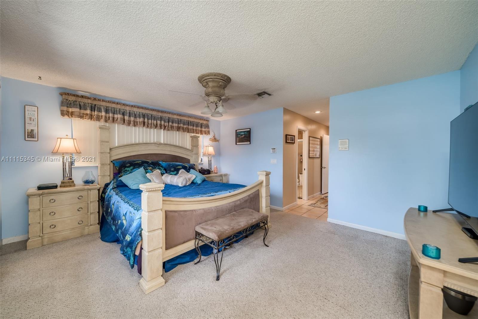 7921 Northwest 90th Avenue Tamarac, FL 33321 - Photo 26 of 69 a bed room with a bed and a chair