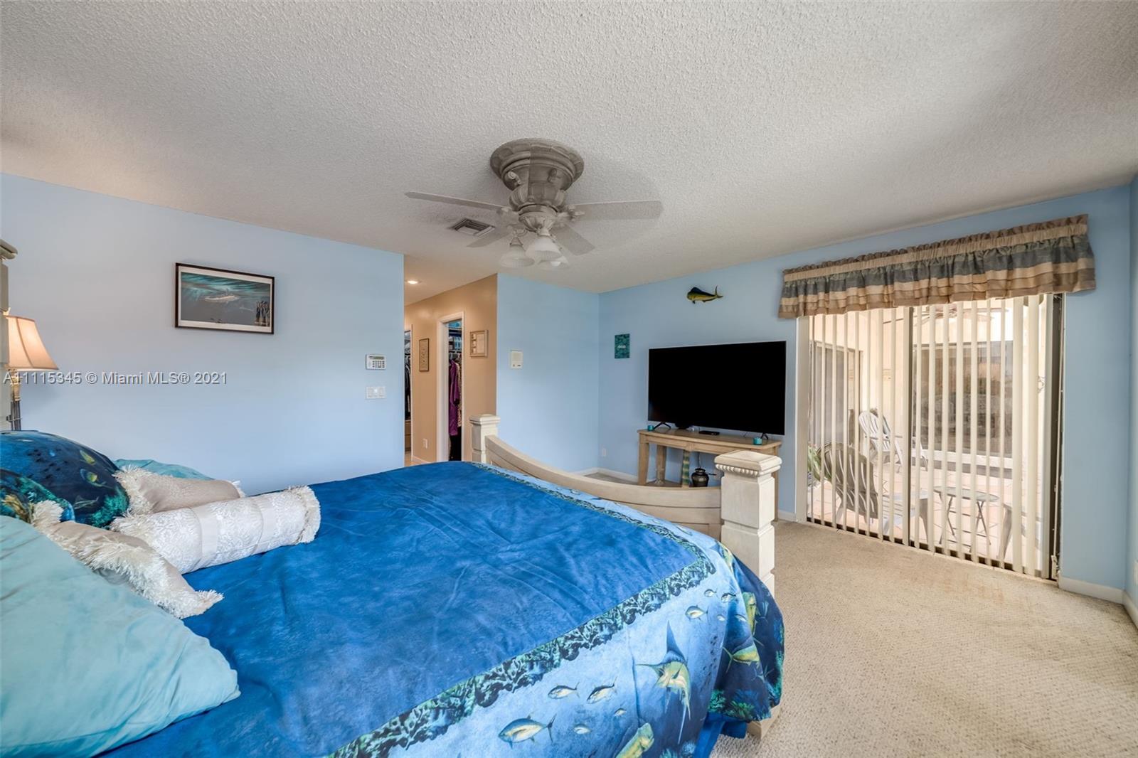 7921 Northwest 90th Avenue Tamarac, FL 33321 - Photo 27 of 69 a bedroom with a bed and a flat screen tv