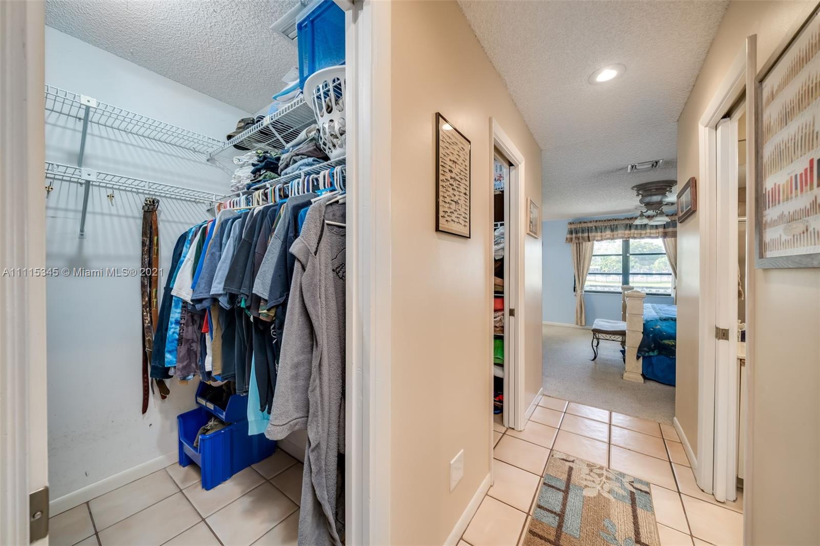 7921 Northwest 90th Avenue Tamarac, FL 33321 - Photo 28 of 69 a view of walk in closet with clothes and shoes