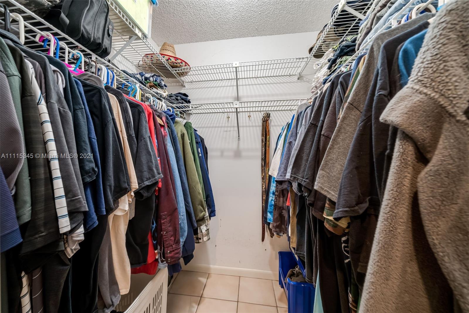 7921 Northwest 90th Avenue Tamarac, FL 33321 - Photo 29 of 69 a view of walk in closet with clothes and shoes