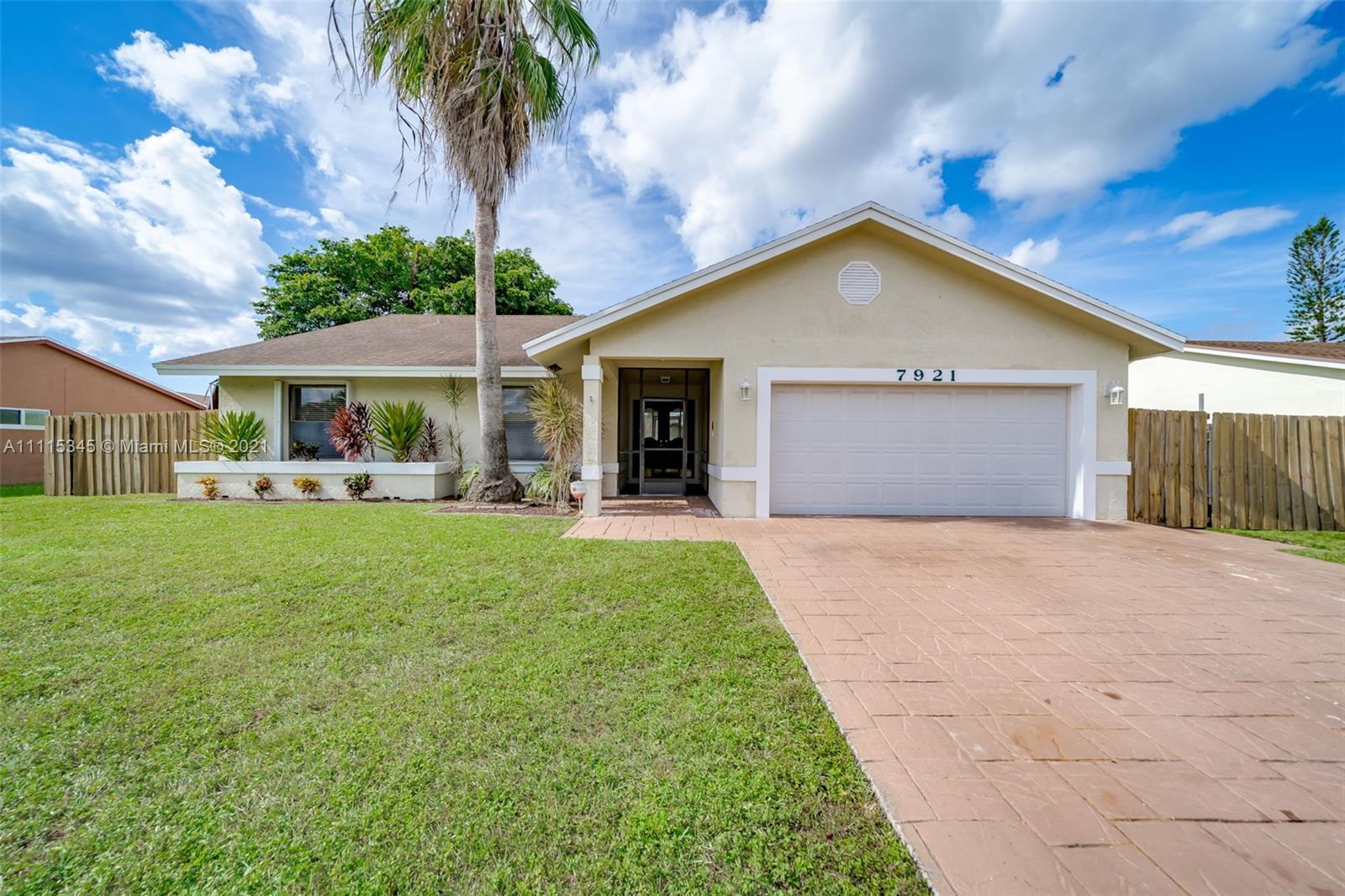 7921 Northwest 90th Avenue Tamarac, FL 33321 - Photo 3 of 69 a view of a house with a yard and potted plants