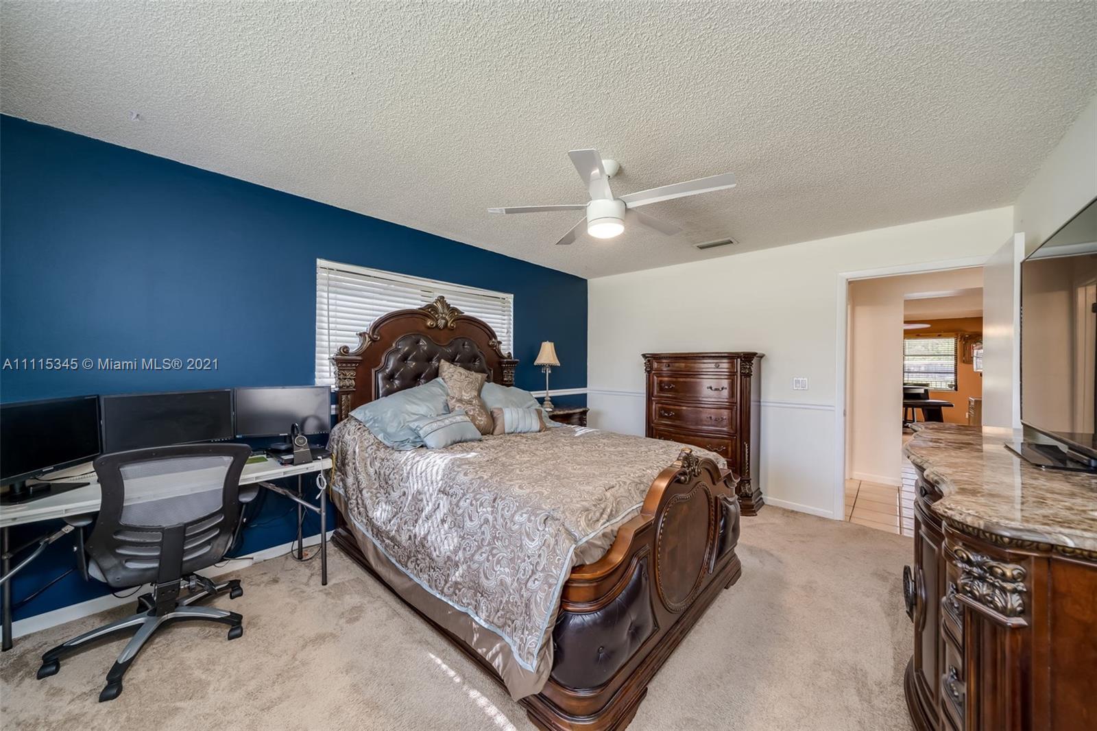 7921 Northwest 90th Avenue Tamarac, FL 33321 - Photo 33 of 69 a bedroom with a bed a desk and chair