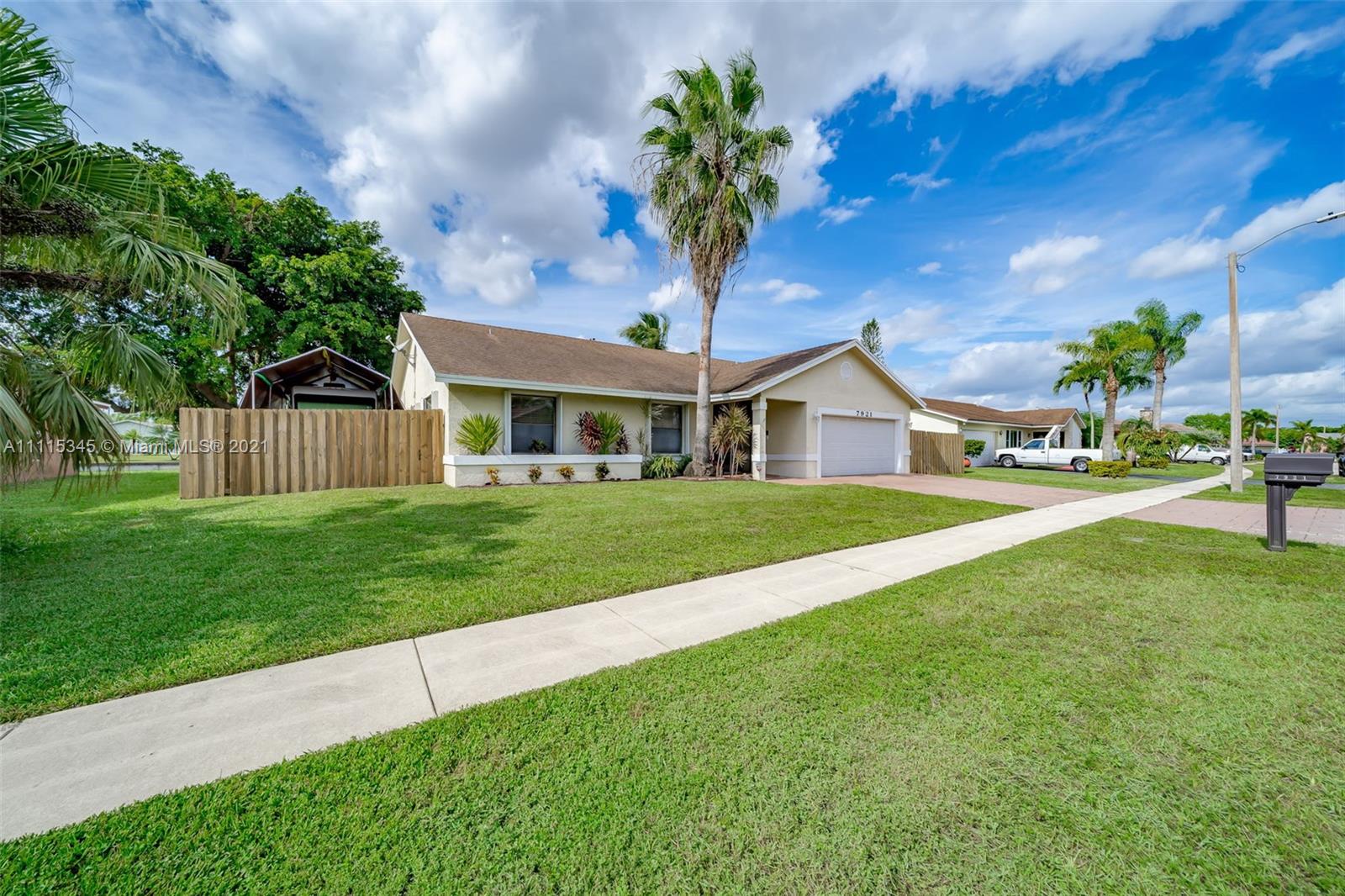 7921 Northwest 90th Avenue Tamarac, FL 33321 - Photo 4 of 69 a front view of a house with garden