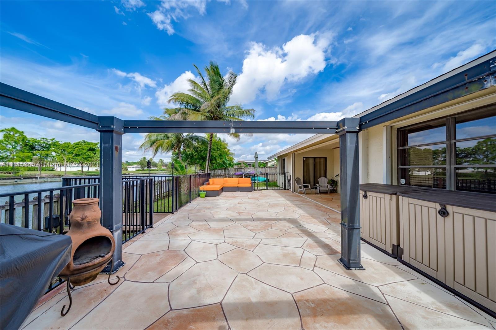 7921 Northwest 90th Avenue Tamarac, FL 33321 - Photo 44 of 69 a view of a porch with furniture and garden