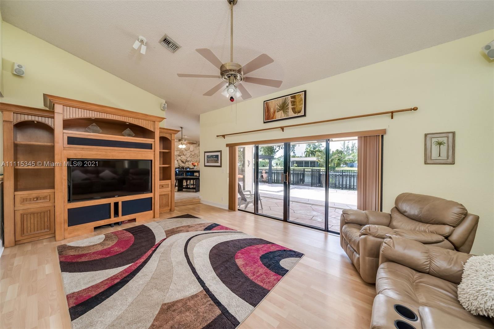 7921 Northwest 90th Avenue Tamarac, FL 33321 - Photo 9 of 69 a living room with furniture a flat screen tv and a large window