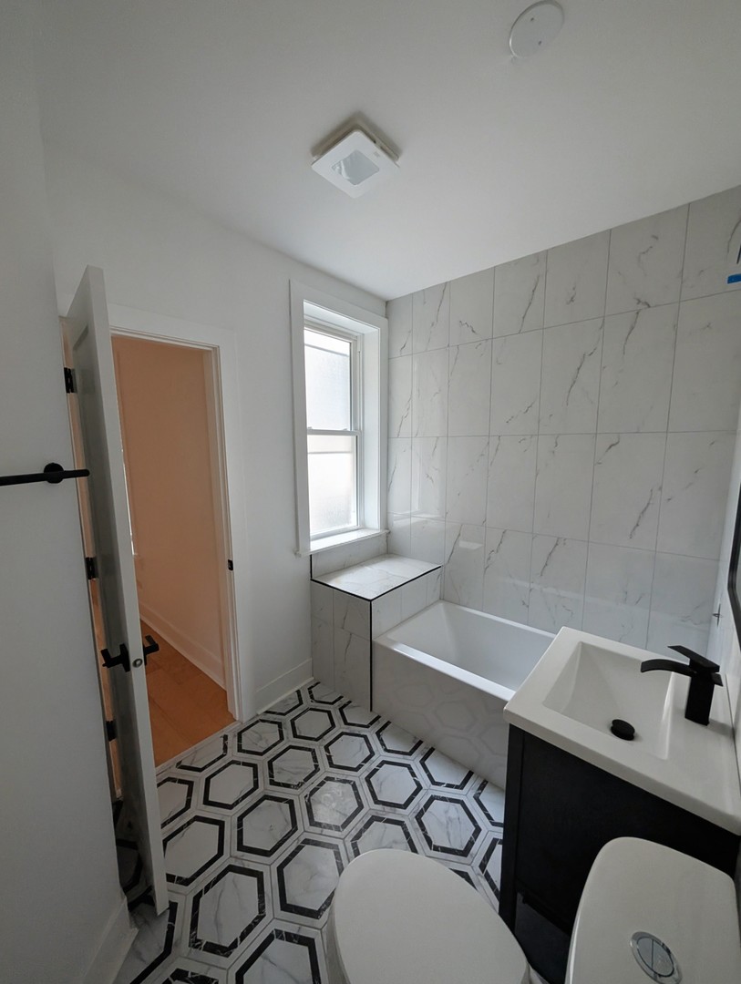 616 West Patterson Avenue, Unit 2W Chicago, IL 60613 - Photo 11 of 18 a bathroom with a sink and a mirror