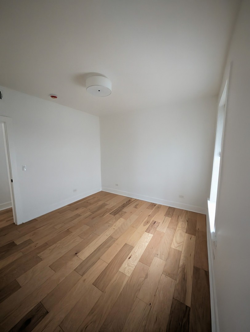 616 West Patterson Avenue, Unit 2W Chicago, IL 60613 - Photo 12 of 18 a view of empty room with wooden floor