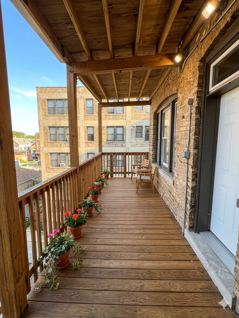 616 West Patterson Avenue, Unit 2W Chicago, IL 60613 - Photo 16 of 18 a view of a balcony with wooden floor