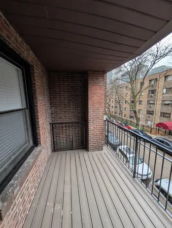 a view of a balcony with wooden floor
