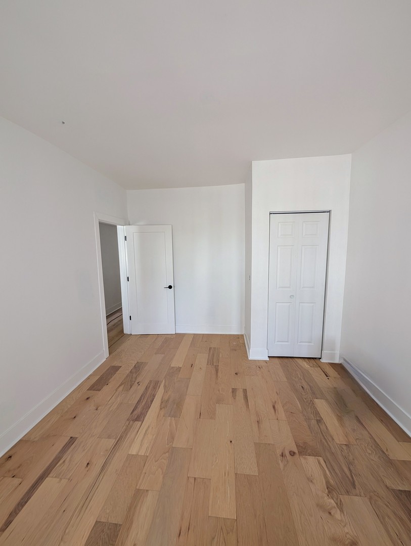 616 West Patterson Avenue, Unit 2W Chicago, IL 60613 - Photo 7 of 18 a view of an empty room and wooden floor