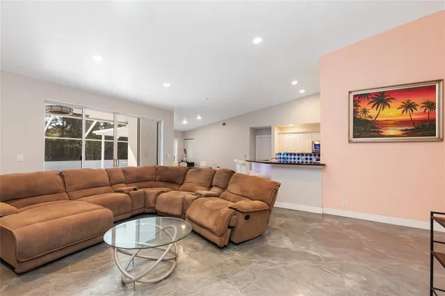 a kitchen with stainless steel appliances kitchen island granite countertop a table and chairs