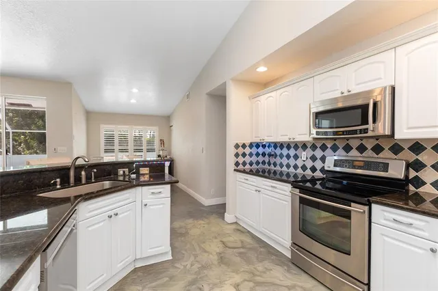 a view of a house with backyard and porch