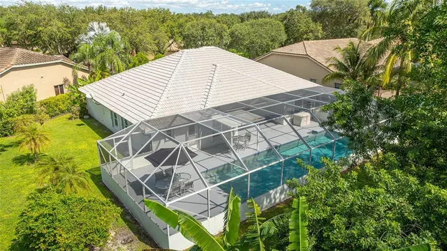 a aerial view of a house with a yard and balcony