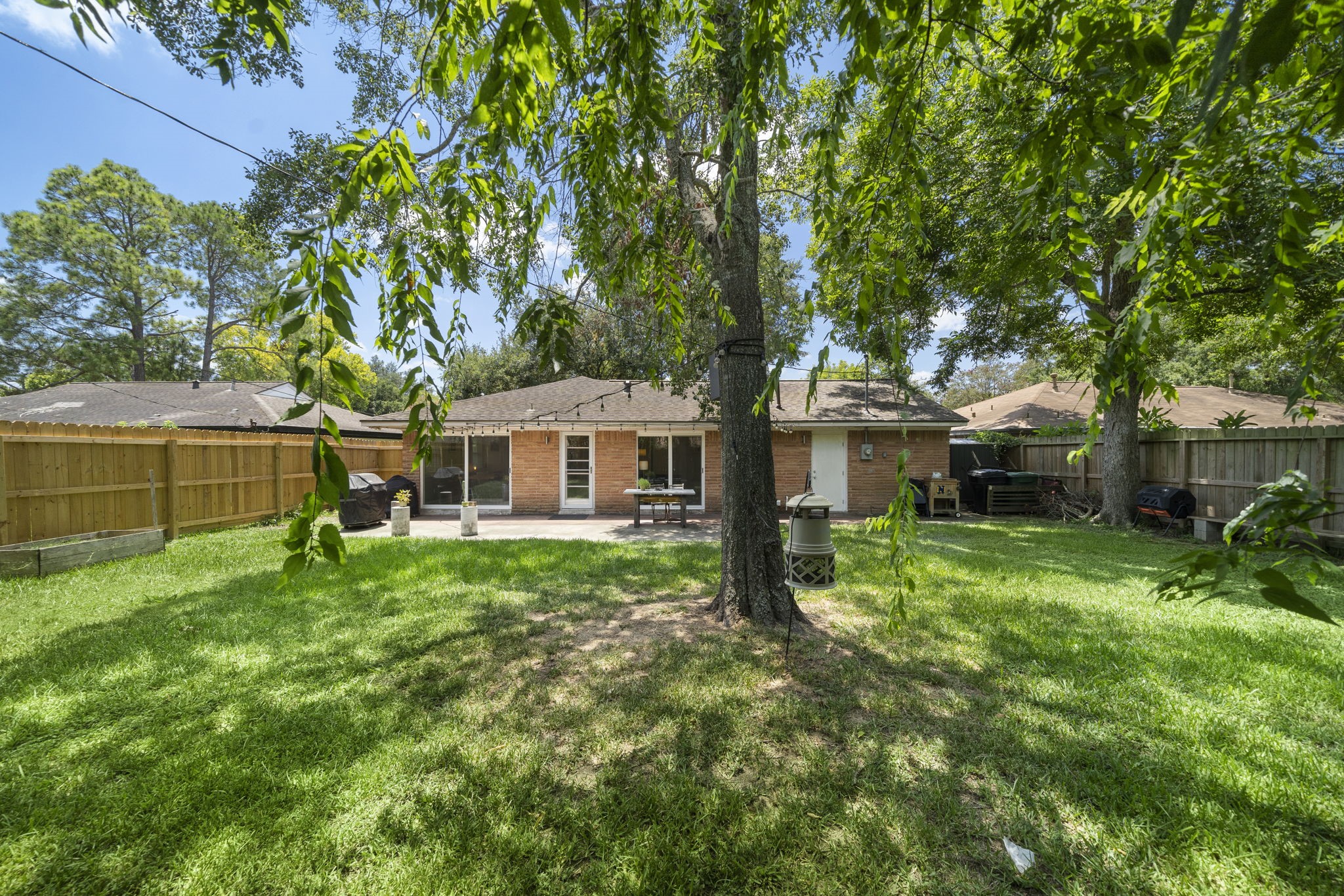 4306 Warm Springs Road Houston, TX 77035 - Photo 34 of 36 Picture from 2023. added Shade cover for patio and tree in middle removed