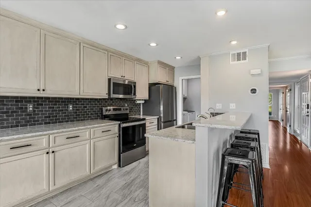 a kitchen with sink microwave and stove