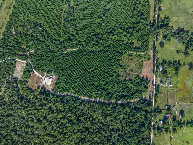 an aerial view of a houses with a yard