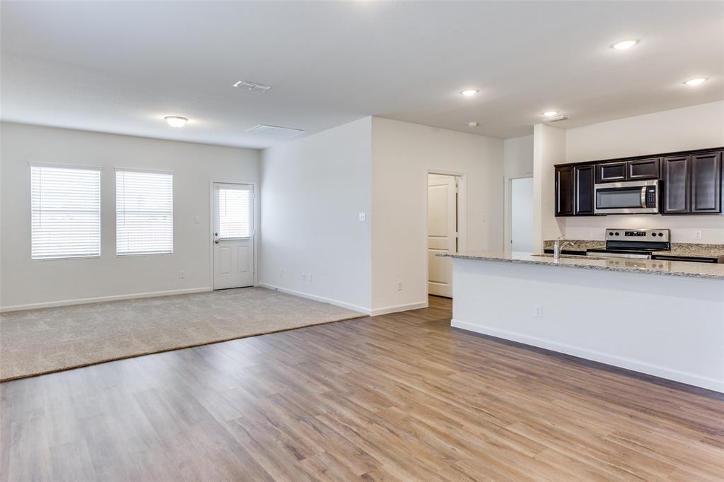 1816 Wolf Run Anna, TX 75409 - Photo 2 of 11 a view of kitchen with microwave a stove and wooden floor