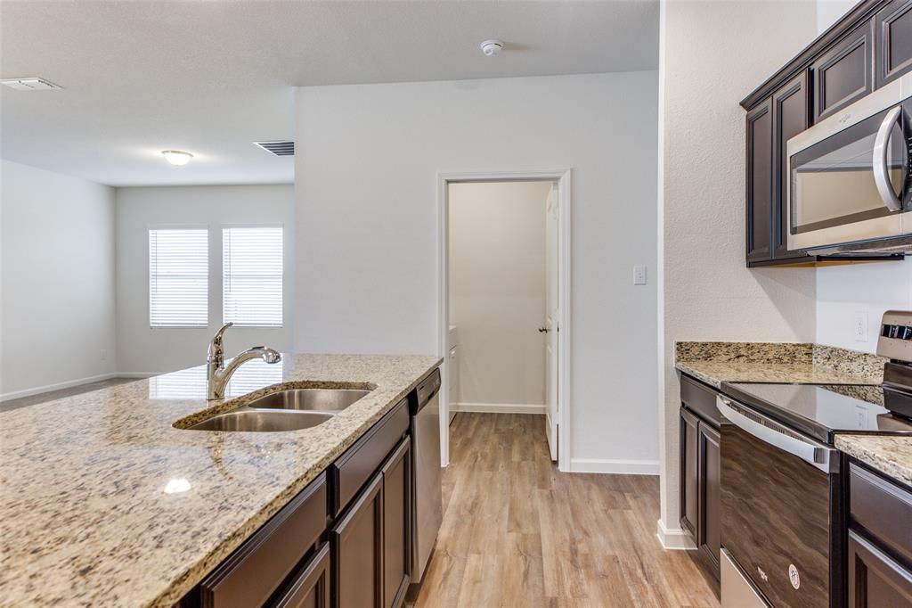 1816 Wolf Run Anna, TX 75409 - Photo 4 of 11 a kitchen that has a sink and a stove