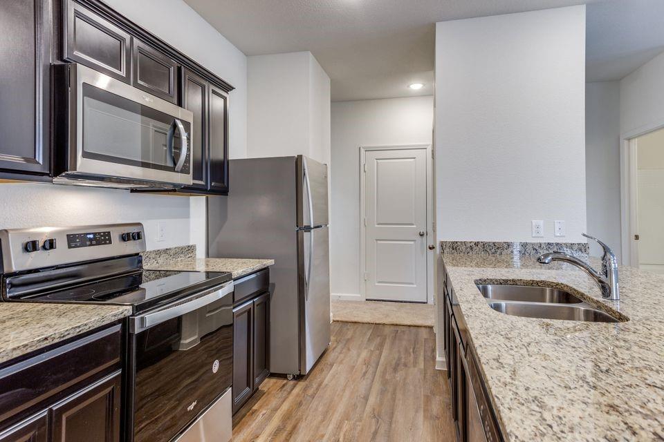 1816 Wolf Run Anna, TX 75409 - Photo 5 of 11 a kitchen with a refrigerator stove and sink