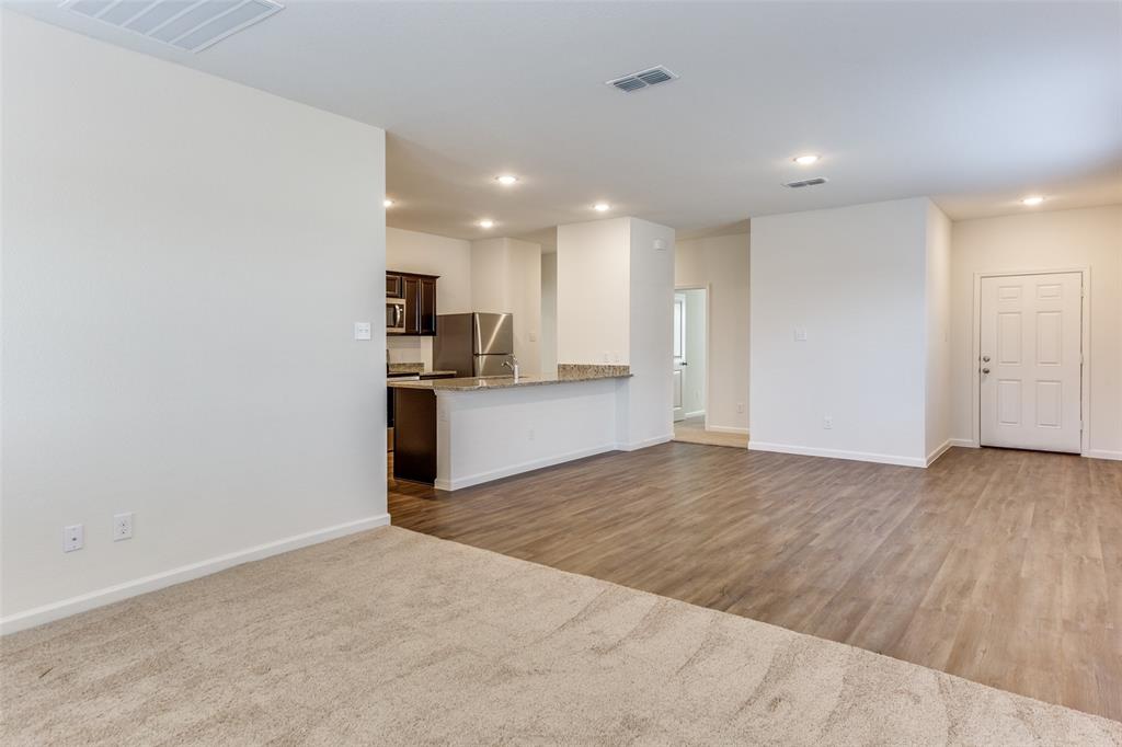 1816 Wolf Run Anna, TX 75409 - Photo 6 of 11 a view of a kitchen with a sink and a refrigerator