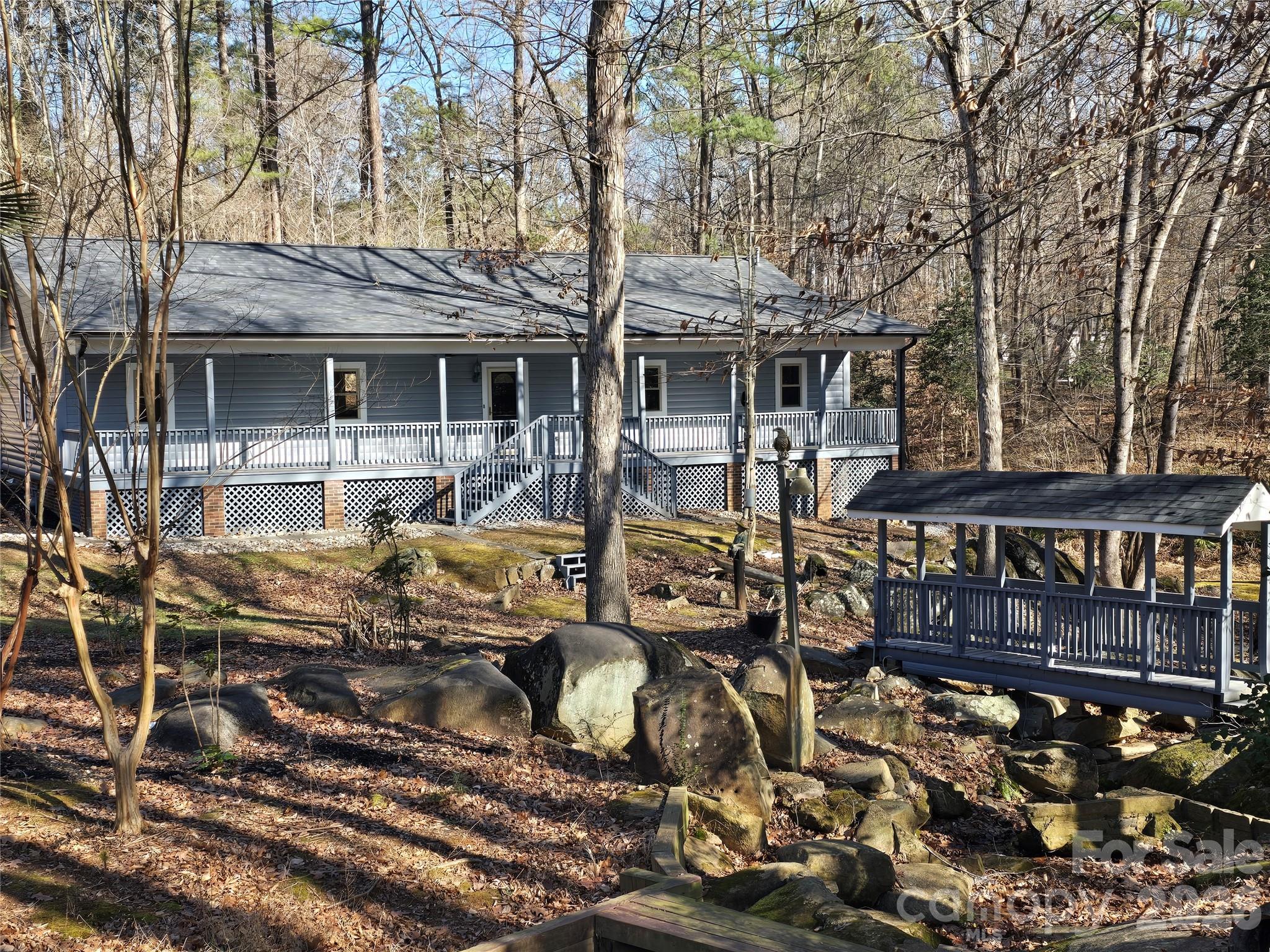 6802 Lowesville Lane Stanley, NC 28164 - Photo 1 of 25 a front view of a house with sitting area