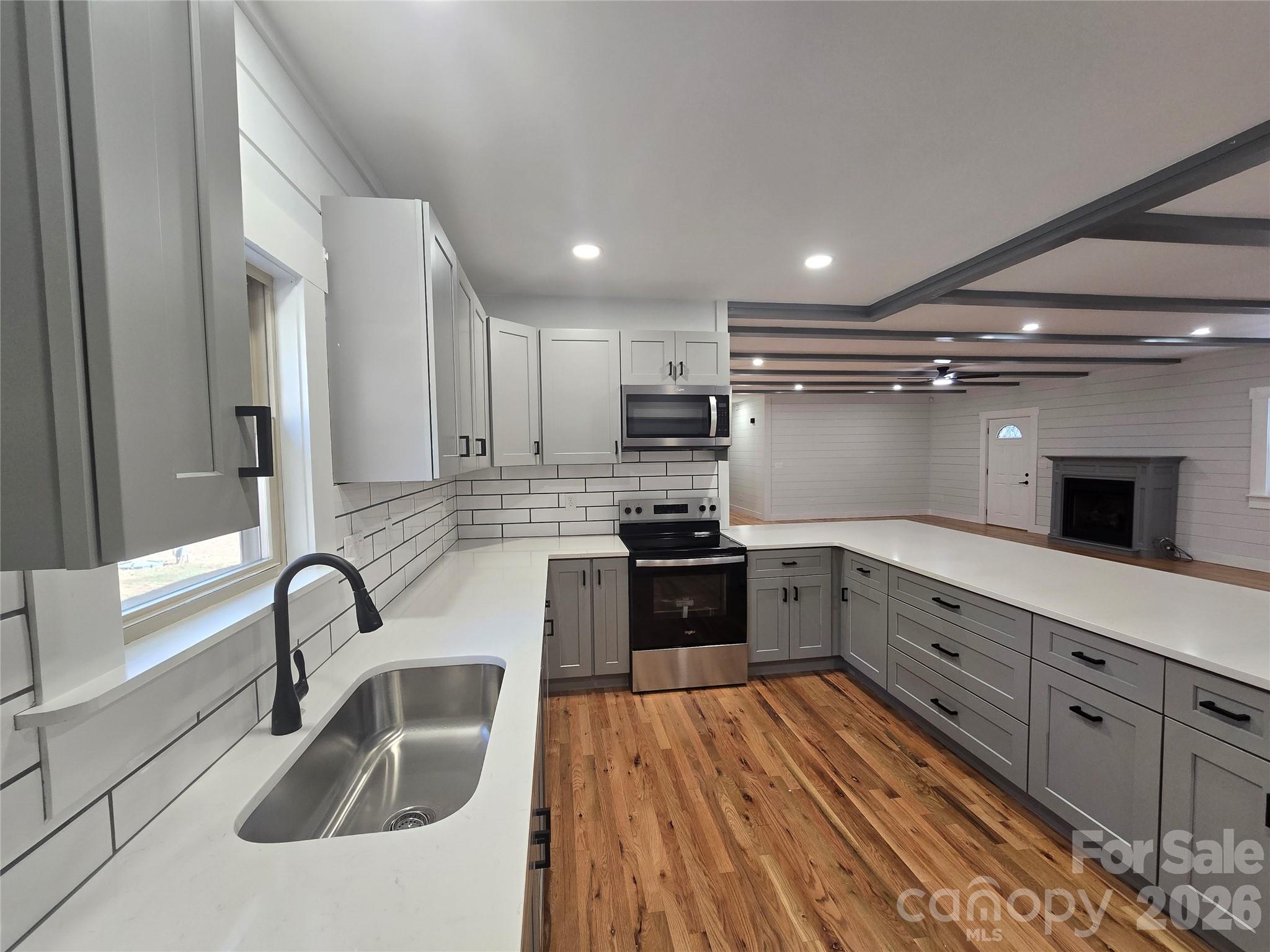 6802 Lowesville Lane Stanley, NC 28164 - Photo 14 of 25 a kitchen with granite countertop a sink stainless steel appliances and cabinets