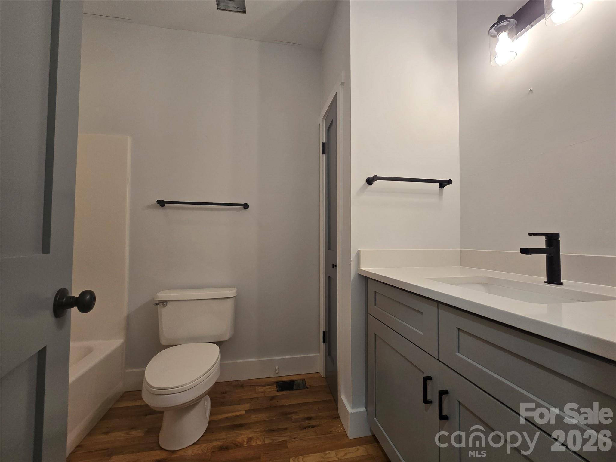 6802 Lowesville Lane Stanley, NC 28164 - Photo 17 of 25 a bathroom with a granite countertop toilet and a sink