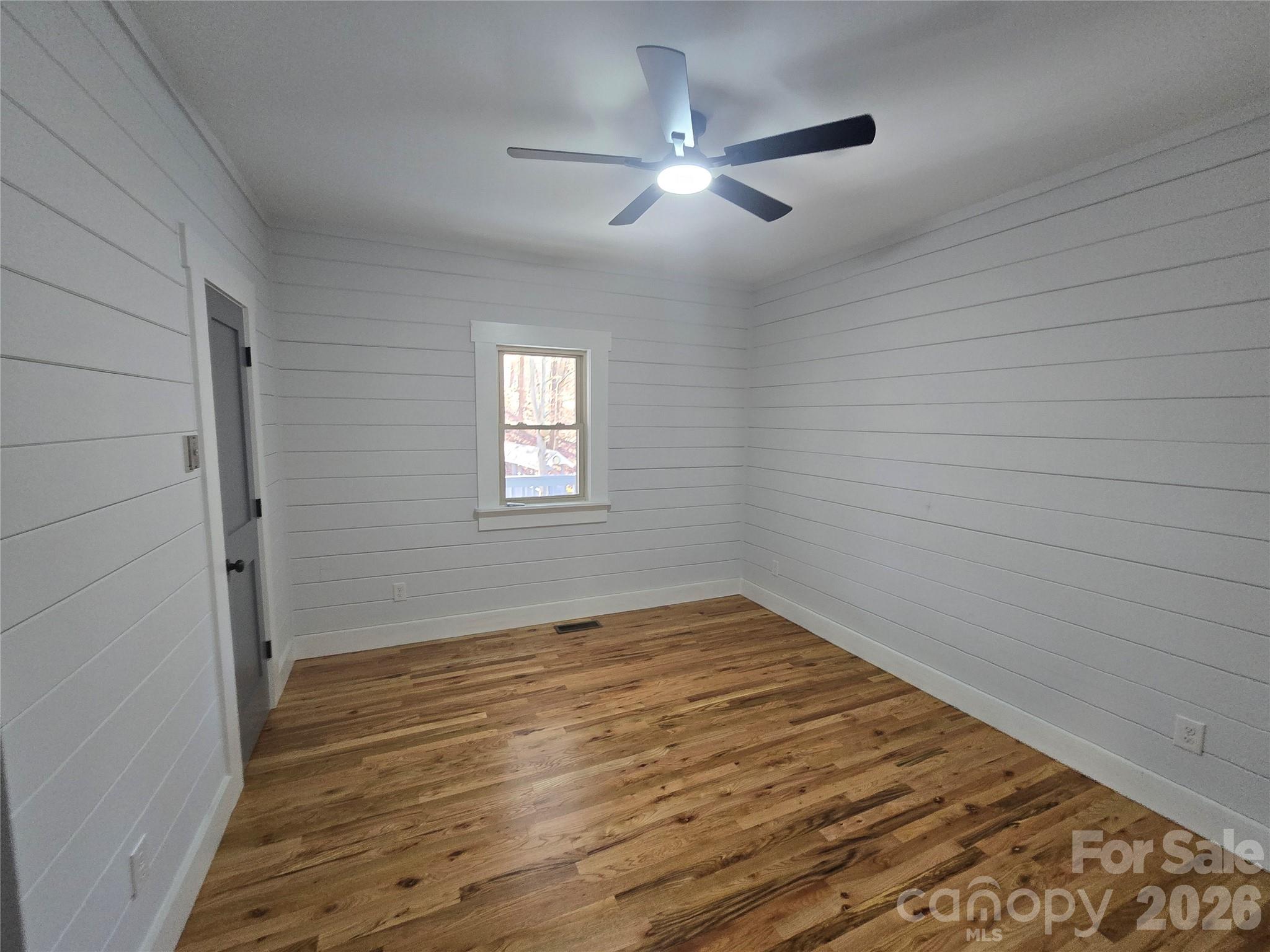 6802 Lowesville Lane Stanley, NC 28164 - Photo 19 of 25 a view of an empty room with wooden floor and a window