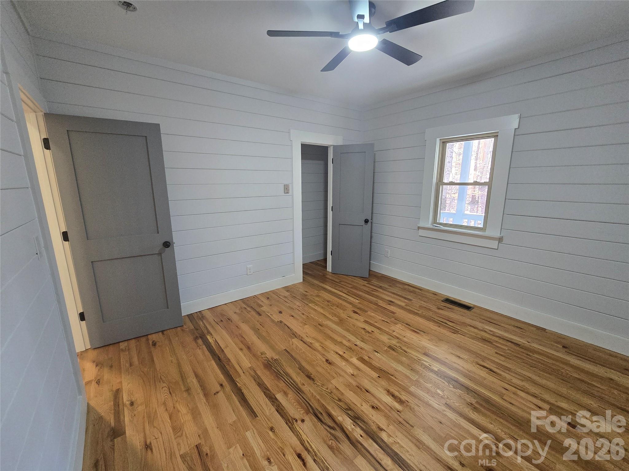6802 Lowesville Lane Stanley, NC 28164 - Photo 20 of 25 a view of empty room with wooden floor and fan