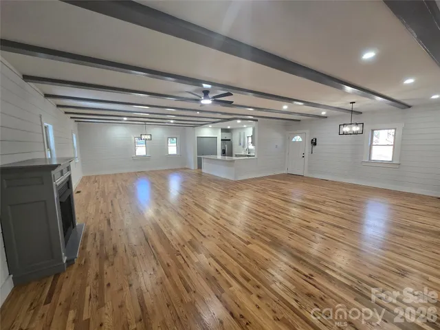 a view of wooden floor and windows in an empty room