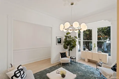 a bedroom with bed and a painting on the wall