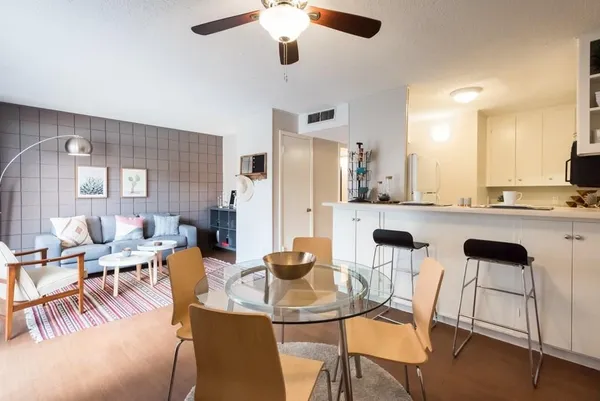 a view of a dining room with furniture and a chandelier