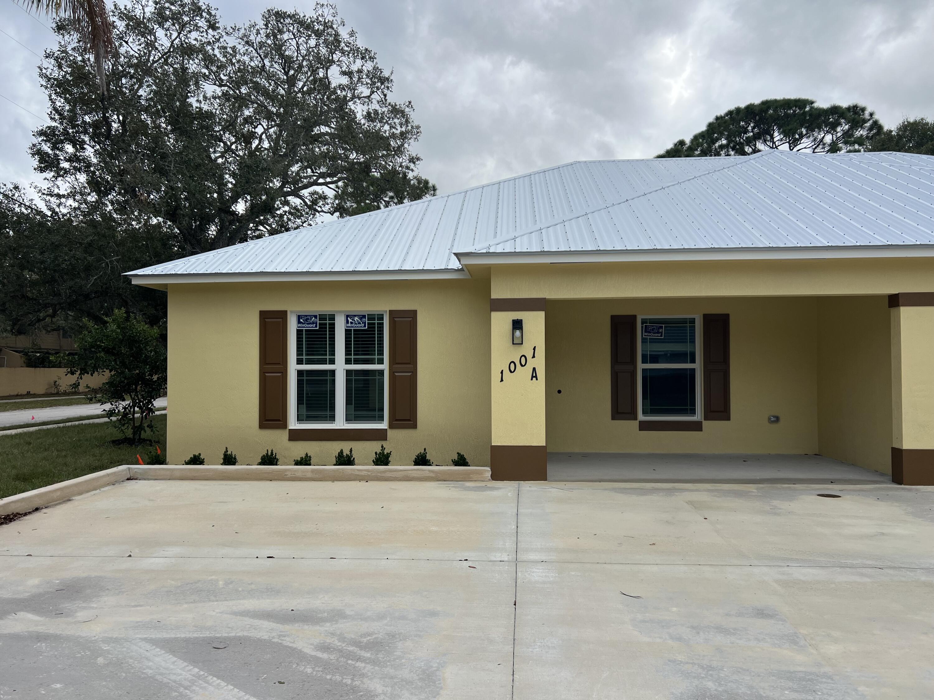 1001 Tennessee Avenue, Unit A Fort Pierce, FL 34950 - Photo 2 of 11 a front view of a house with a garden