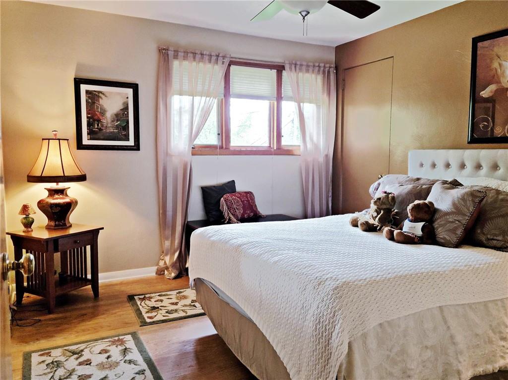 5184 Richland Road Gibsonia, PA 15044 - Photo 12 of 23 a bedroom with a bed and wooden floor