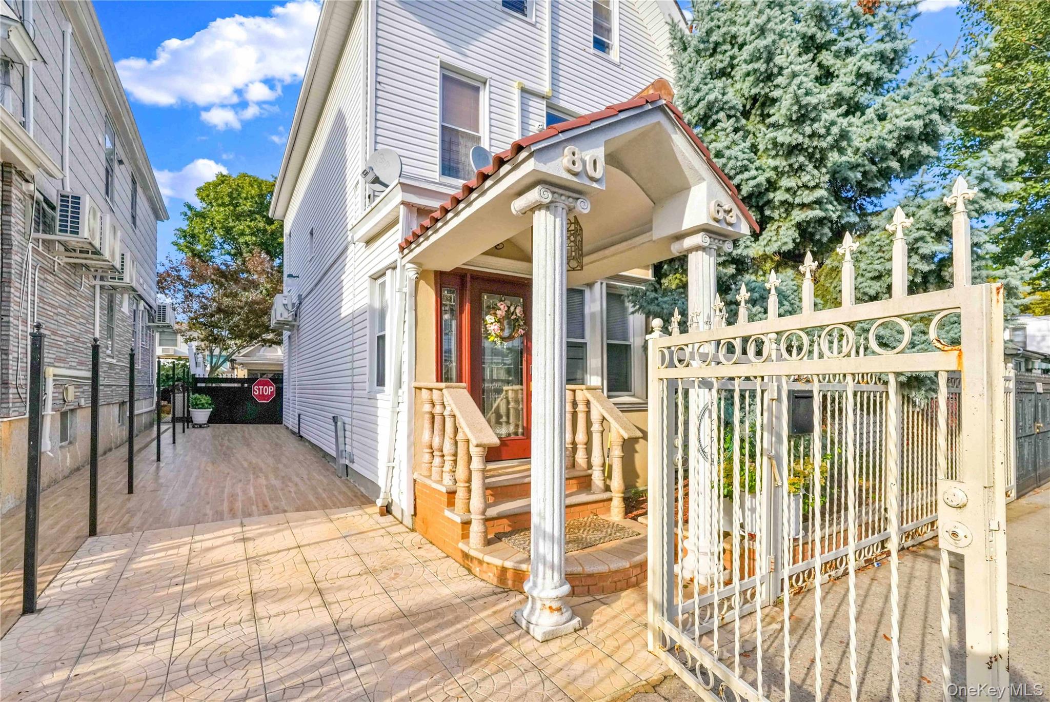 80-63 87th Road Queens, NY 11421 - Photo 6 of 37 a view of a white house with iron fence