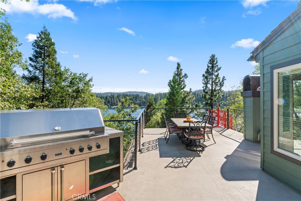 28019 North Shore Road Lake Arrowhead, CA 92352 - Photo 10 of 30 a roof deck with table and chairs a barbeque and potted plants