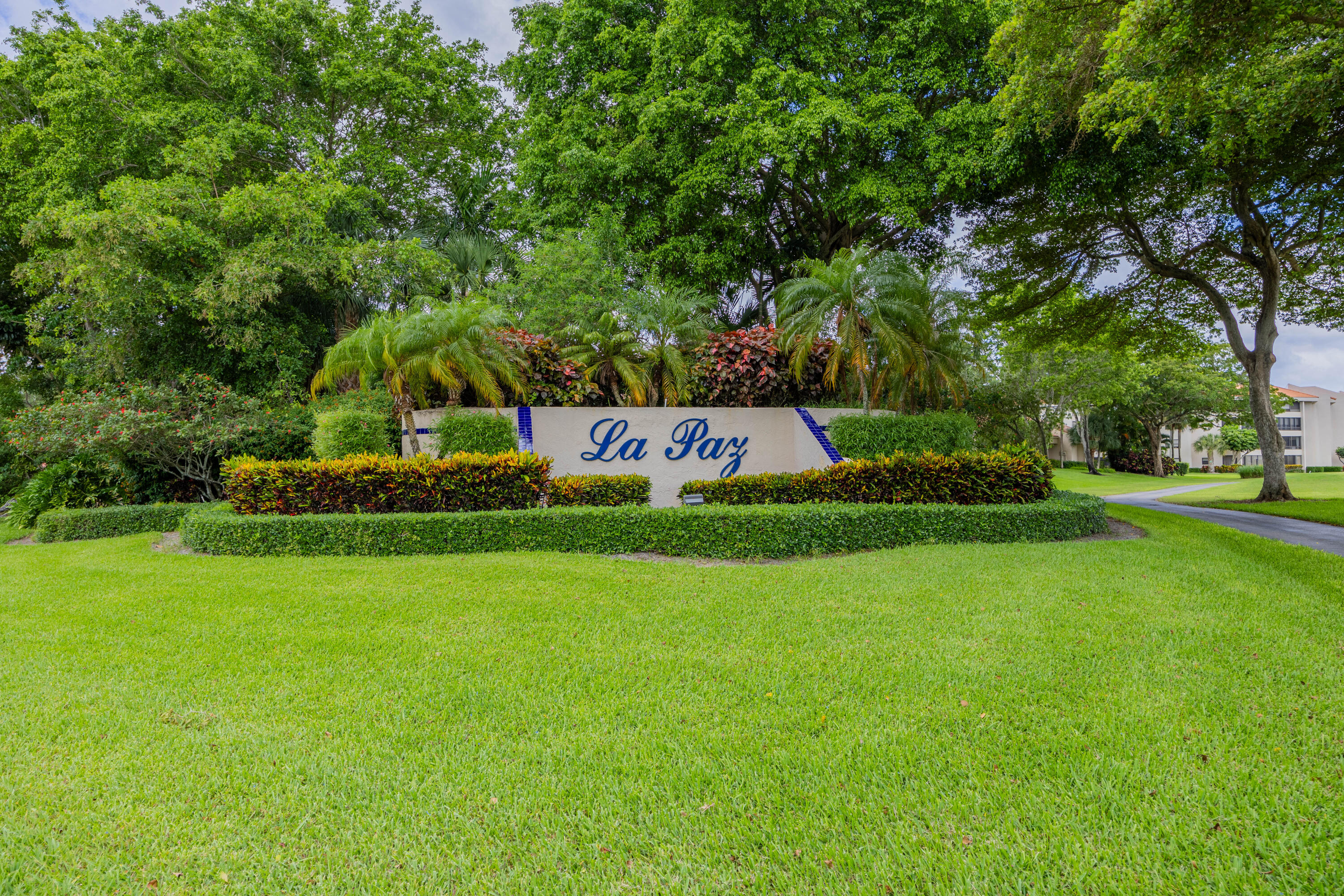 7520 La Paz Boulevard, Unit 104 Boca Raton, FL 33433 - Photo 54 of 56 a sign that is sitting in the grass