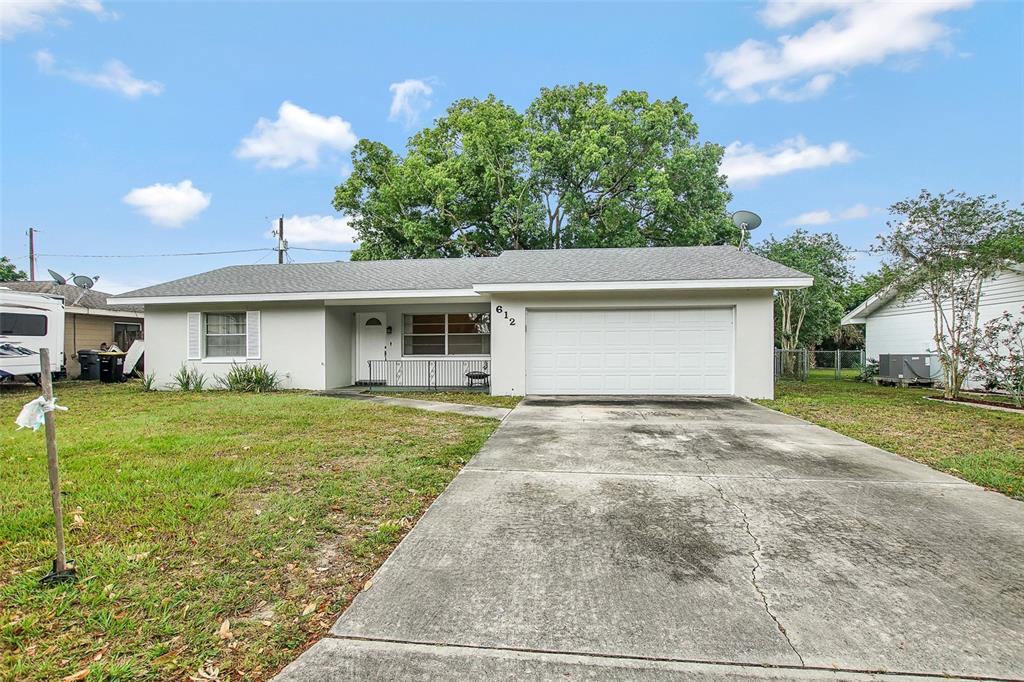 612 Lake Ned Road Winter Haven, FL 33884 - Photo 1 of 1 a front view of a house with a yard and garage