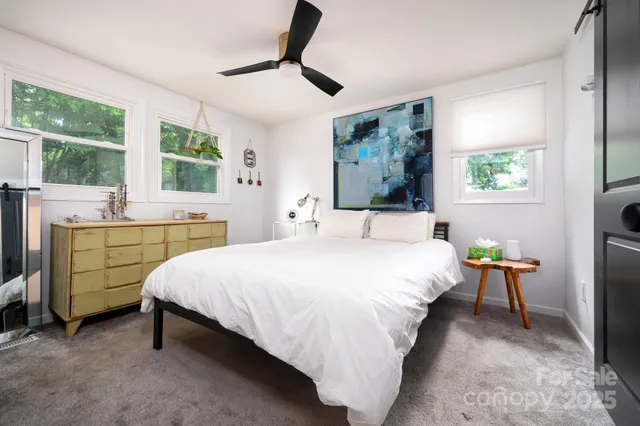 a bed room with a bed and a chair