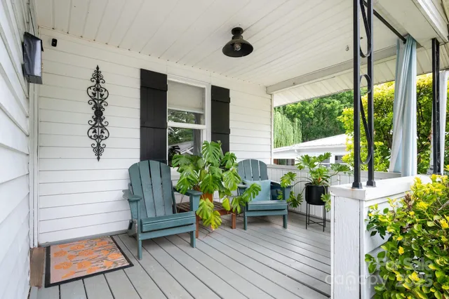 a view of a deck with furniture and garden
