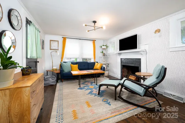 a living room with furniture a fireplace and a flat screen tv