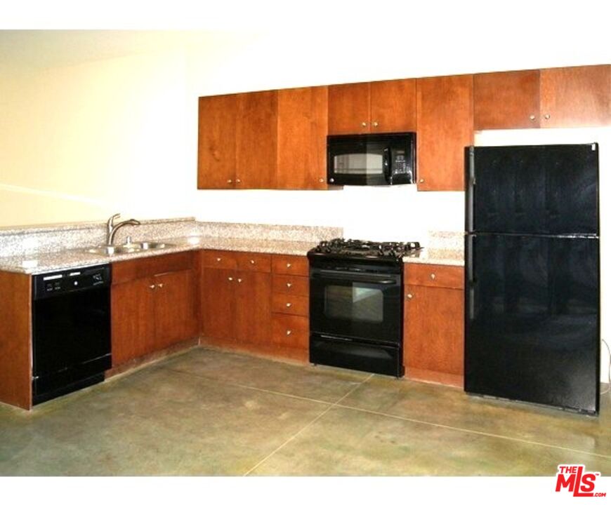 228 Sandy Point Trail Palm Springs, CA 92262 - Photo 9 of 12 a kitchen with stainless steel appliances granite countertop a stove a refrigerator and a sink