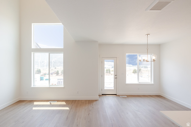 5228 South Acacia Drive, Unit 808 Mapleton, UT 84664 - Photo 12 of 22 Spacious open room featuring wood-finish flooring, soaring ceilings, and multiple windows