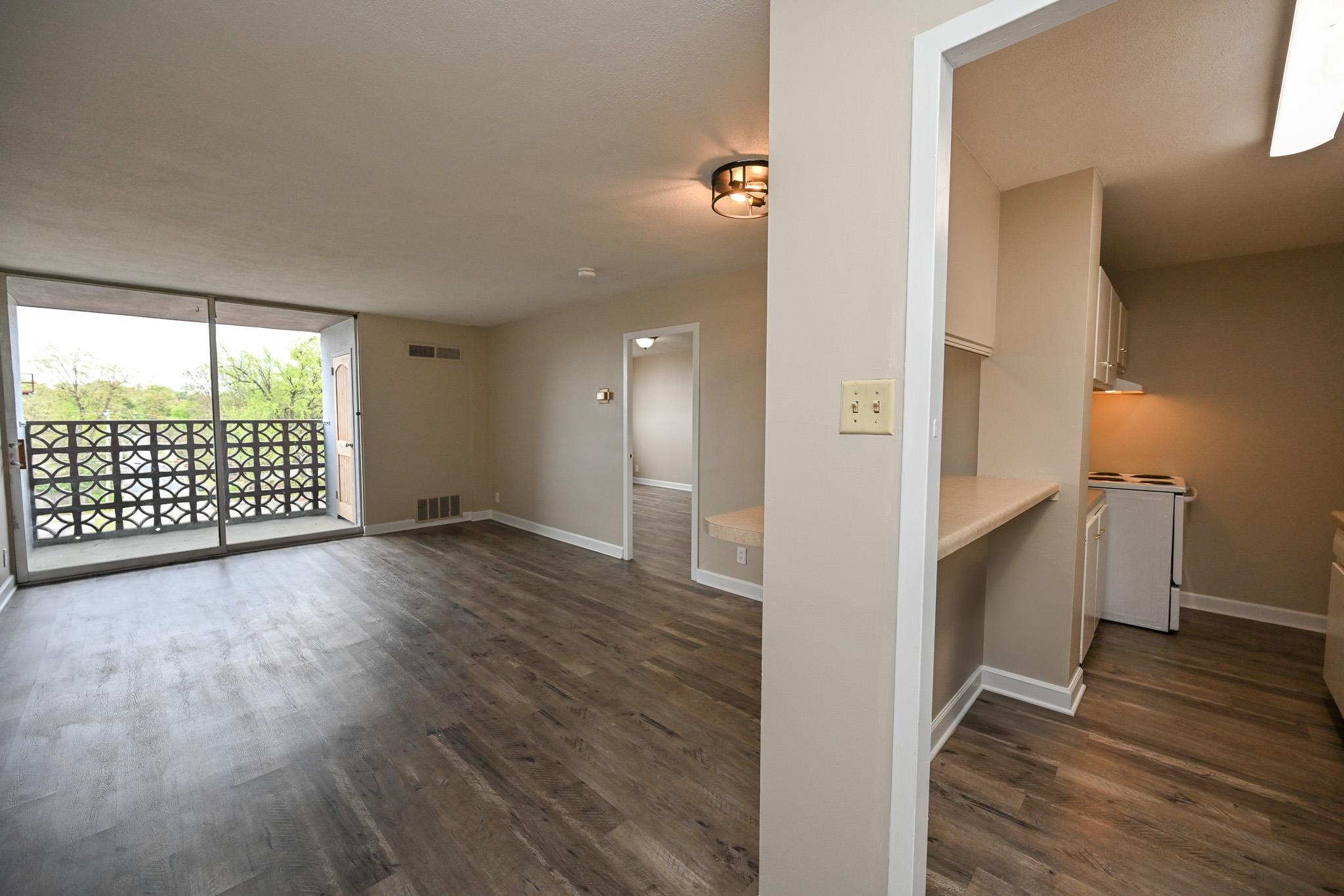 2277 Union Avenue, Unit 408 Memphis, TN 38104 - Photo 1 of 31 a view of an empty room with wooden floor and a window