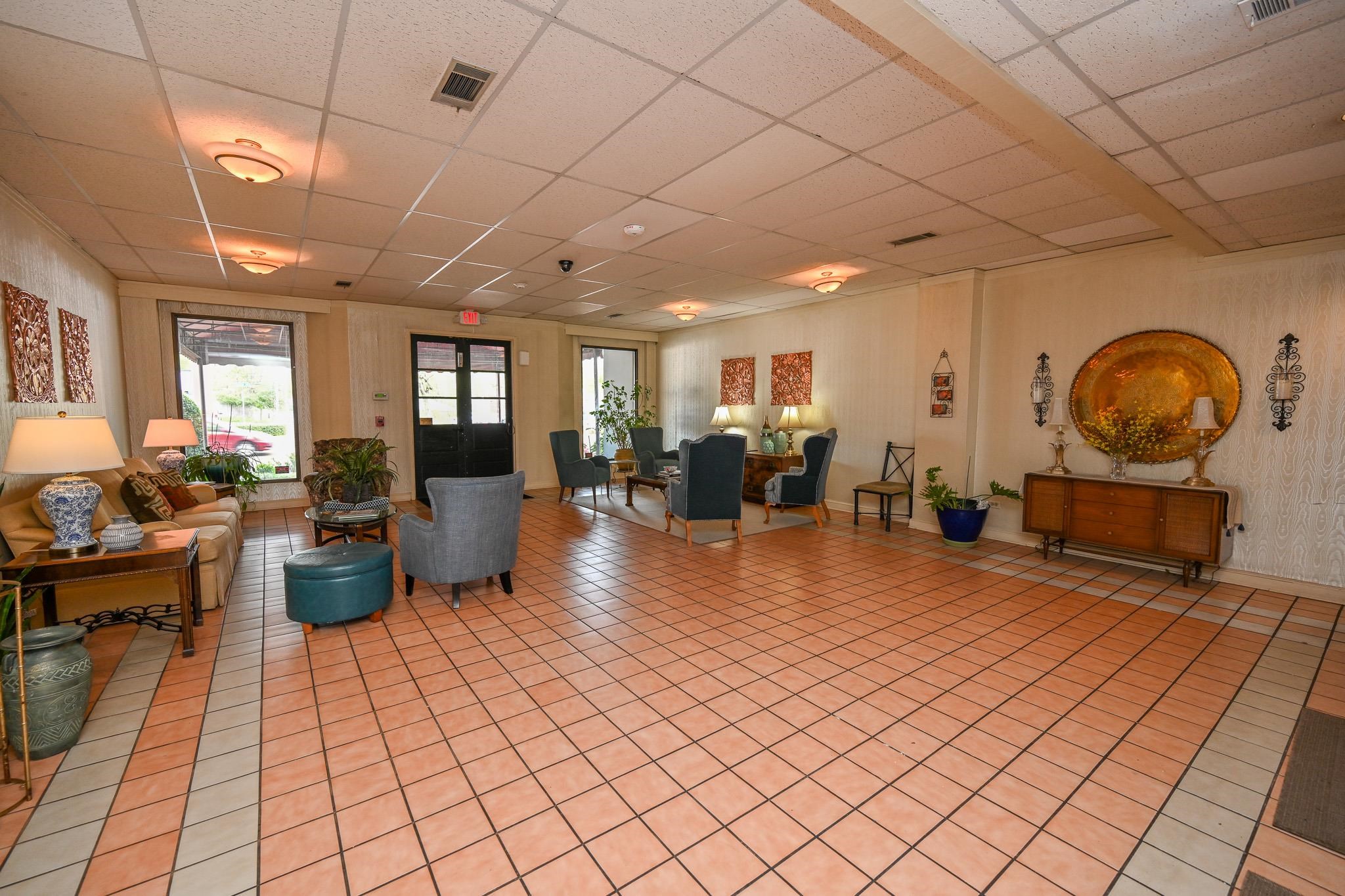 2277 Union Avenue, Unit 408 Memphis, TN 38104 - Photo 17 of 31 a living room with lots of furniture and a chandelier
