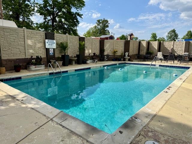 2277 Union Avenue, Unit 408 Memphis, TN 38104 - Photo 25 of 31 a view of a swimming pool with a chair and tables